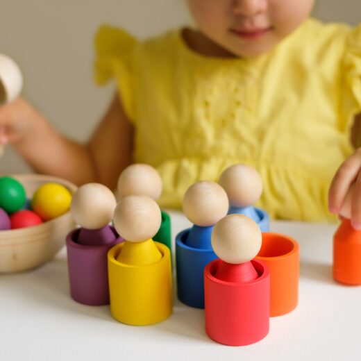 Little girl playing with shapes and blocks.