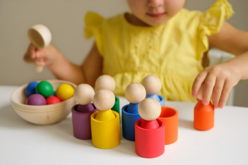 Little girl playing with shapes and blocks.