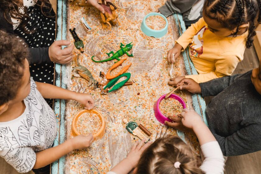 A group of children playing with plastic toys.