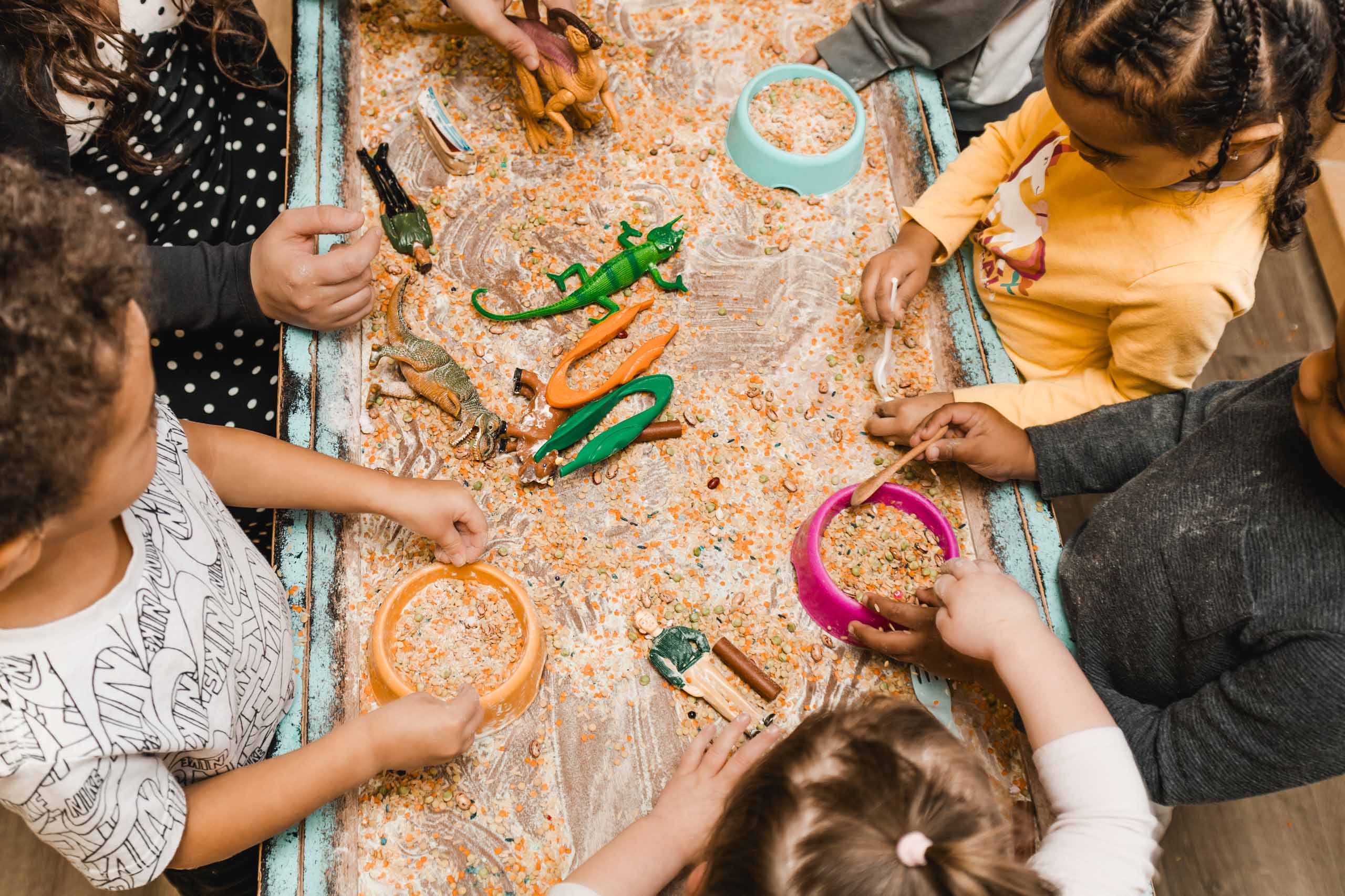 A group of children playing with plastic toys.