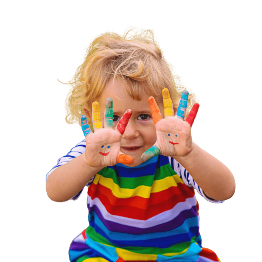 A little boy holding up his hands covered in rainbow paint.